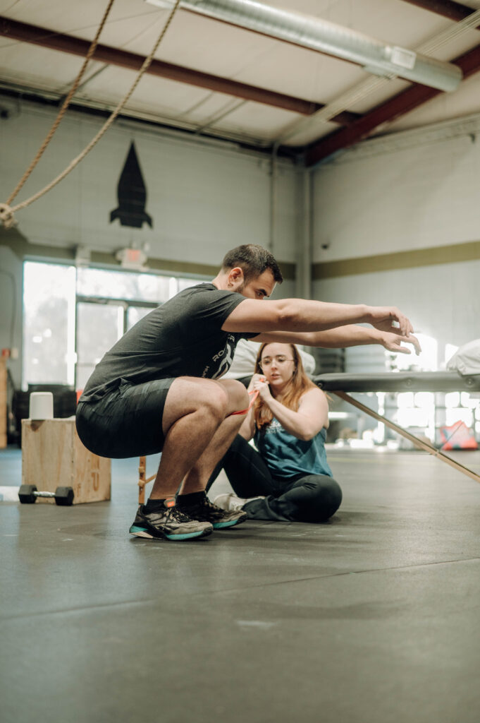 Physical therapist working on a squat with patient
