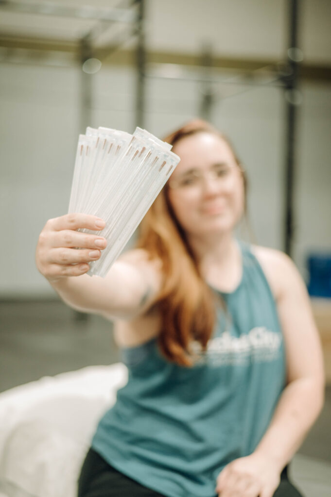 person holding up dry needling packages