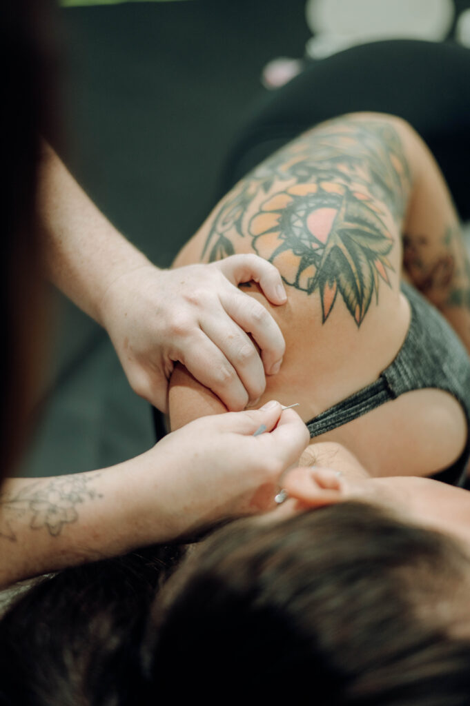 therapist hands working on a shoulder