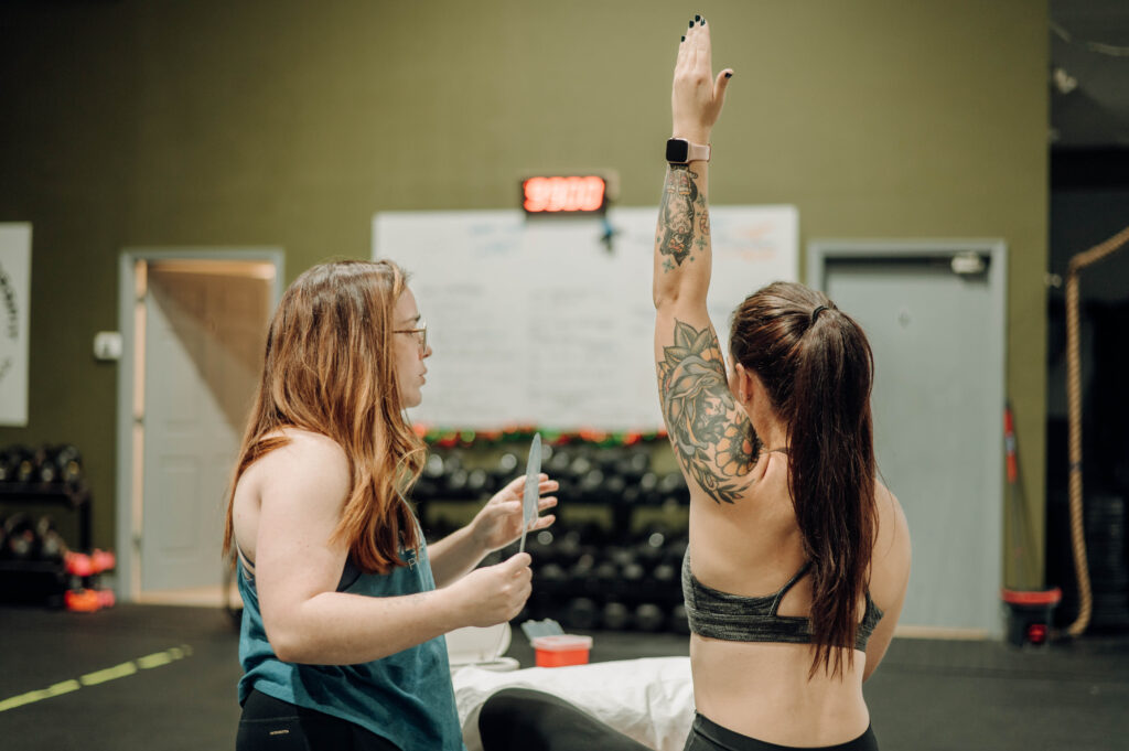 physical therapist working with patient on shoulder range of motion